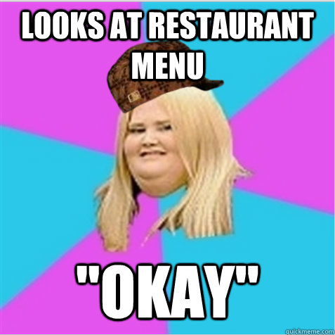 looks at restaurant menu 