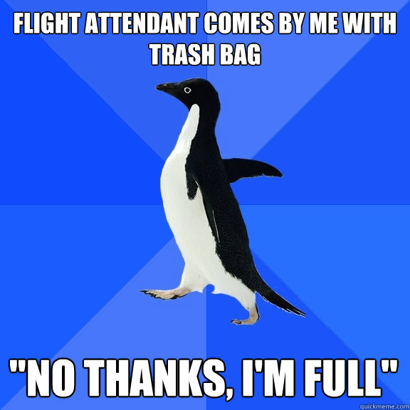 Flight attendant comes by me with trash bag 