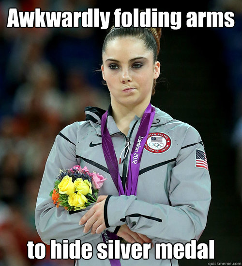 Awkwardly folding arms to hide silver medal  McKayla Not Impressed