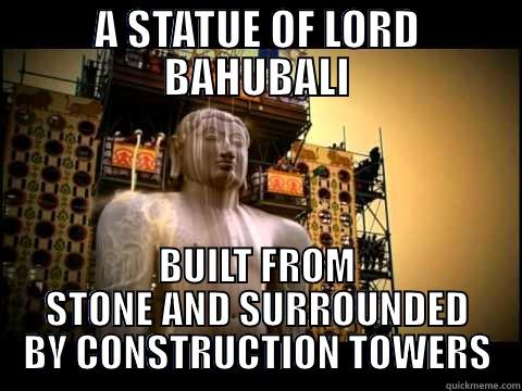 A STATUE OF LORD BAHUBALI BUILT FROM STONE AND SURROUNDED BY CONSTRUCTION TOWERS Misc