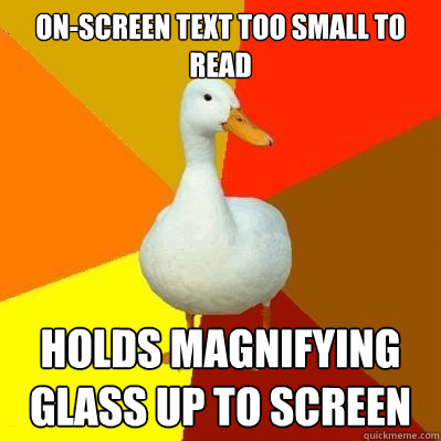 on-screen text too small to read holds magnifying glass up to screen  Tech Impaired Duck