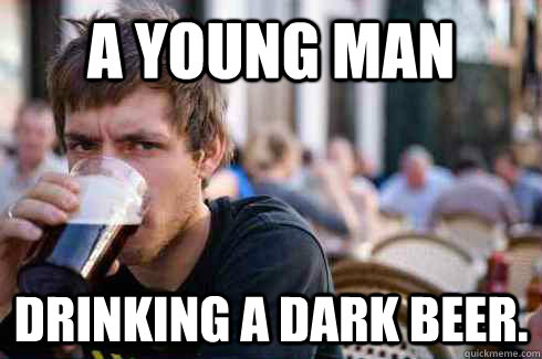 A young man drinking a dark beer.  Lazy College Senior