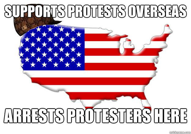 SUPPORTS PROTESTS OVERSEAS ARRESTS PROTESTERS HERE  
