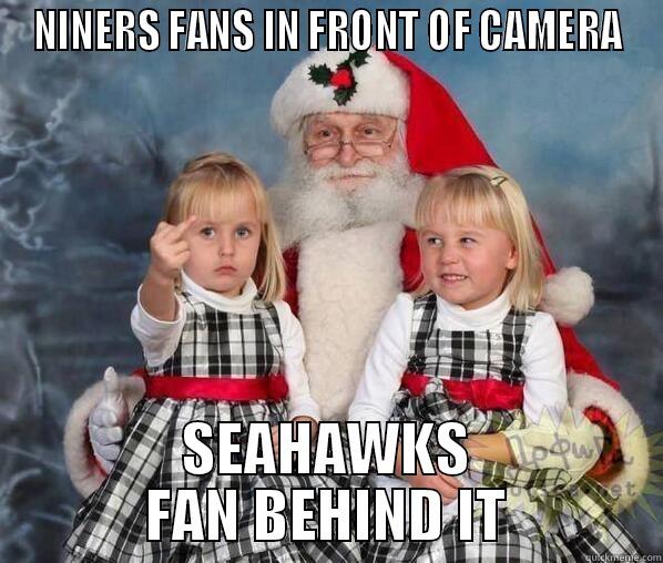 NINERS FANS IN FRONT OF CAMERA SEAHAWKS FAN BEHIND IT Misc