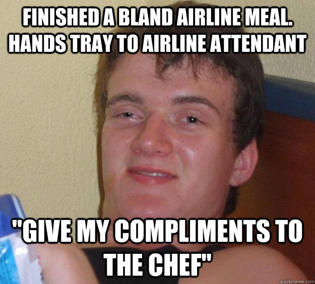 finished a bland airline meal. hands tray to airline attendant  