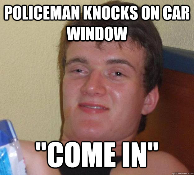 Policeman knocks on car window 